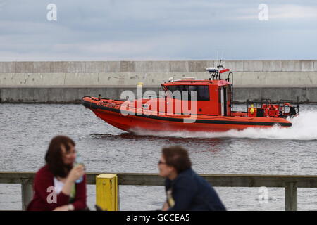 Gdynia, Poland 9th, July 2016 After few rainy and cold days, people enjoy sunny and quite warm weather in Gdynia, on Saturday, 9th of July. Two girl talking in front of orange Naval motorboat are seen Credit:  Michal Fludra/Alamy Live News Stock Photo