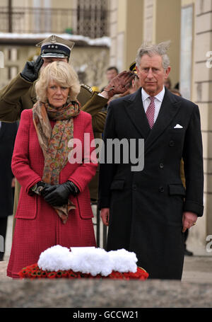 The Prince of Wales and the Duchess of Cornwall, stand for a one minute silence at the Grave of Father Jerzy Popieluszko, in Warsaw Poland, after arriving in the country earlier, this afternoon.