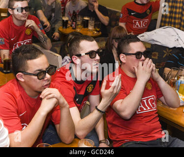 Fans wear special glasses to view a 3D broadcast during the third