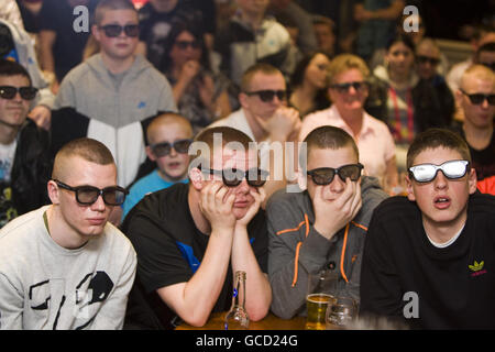 Manchester United fans, wearing 3D glasses, at the Firbank pub in Wythenshawe, Manchester as they join football fans across the country to watch the top of the table clash between Manchester United and Chelsea on Sky 3D, Europe's first 3D TV channel that launched today. Stock Photo