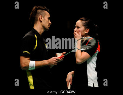 England's Jenny Wallwork (right) stands dejected along with her doubles partner Nathan Robertson (left) as they lose a point against Indonesia's Nova Widianto and Liliyana Natsir (not pictured) during the Yonex All England Open Badminton Championships at the NIA, Birmingham. Stock Photo