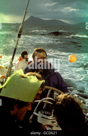AJAX NEWS PHOTOS. 1978. CAPE HORN - WHITBREAD ROUND THE WORLD RACE - ON BOARD CONDOR, CREW CELEBRATE THE ROUNDING OF THE SOUTHERNMOST CAPE; CO-SKIPPER LES WILLIAMS AT THE HELM. PHOTO:GRAHAM CARPENTER/AJAX REF:HDD YA CONDOR 1978 Stock Photo