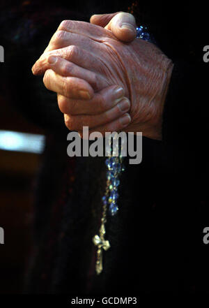 A woman prays during a service at St Patrick's Cathedral in Armagh, Stock Photo
