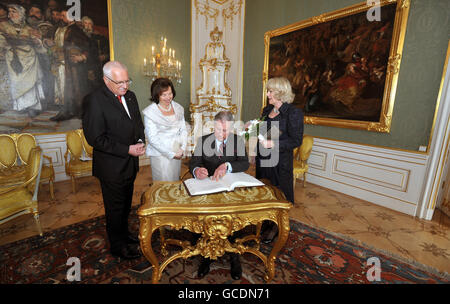 The Prince of Wales signs the visitors book, watched by the Duchess of Cornwall, President Klaus (left) and his wife Livia (second left), before a tour of Prague Castle, after arriving in the Czech capital from Budapest in Hungary. Stock Photo