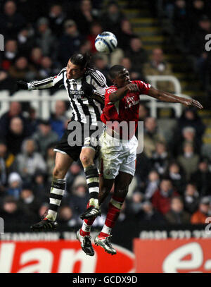 Soccer - Coca-Cola Football League Championship - Newcastle United v Nottingham Forest - St James' Park. Newcastle United's Andy Carroll (left) and Nottingham Forest's Guy Moussi battle for the ball Stock Photo