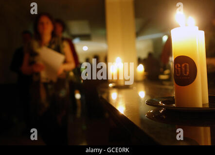 Delegates walk past candles lit for Earth Hour during the Green Party Convention at the Tower Hotel in Waterford, Ireland. Stock Photo