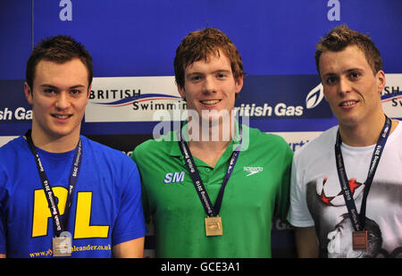 Stockport Metro's Michael Rock (centre) celebrates with his Gold medal for the Men's Open 100m Butterfly with Silver medalist Plymouth Leander's Antony James (left) and Bronze medalist Peterlee's Ian Hulme (right) during the British Swimming Championships at Ponds Forge, Sheffield. Stock Photo