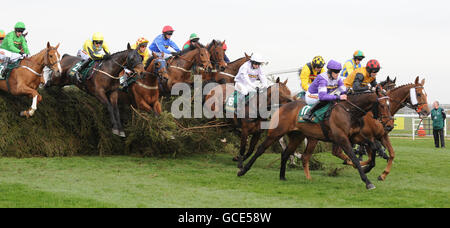 Always Waining ridden by Brian Hughes (right, purple) clears the Chair on his way to victory in the John Smith's Topham Steeple Chase on Ladies Day of the Grand National meeting at Aintree Racecourse, Liverpool. Stock Photo