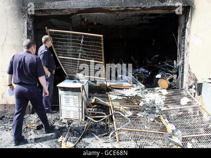 Fire officers at the scene of the fire in Newry Co Down following an arson attack that saw 10 foreign nationals rescued from the flaming apartment block in Co Down which is being treated as a suspected hate crime. Stock Photo