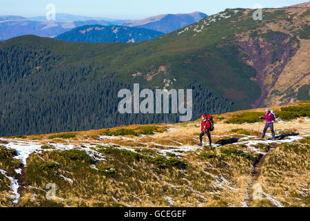 Two Hikers walking along Mountain ridge Stock Photo