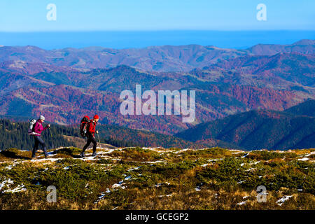 Simple Healthy Lifestyle Concept Image of Two Hikers walking in Mountains Stock Photo