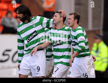 Celtic's Robbie Keane (centre) celebrates scoring their second goal with team mates Georgios Samaras (left) and Aiden McGeady during the Clydesdale Bank Scottish Premier League match at Tannadice Park, Dundee. Stock Photo