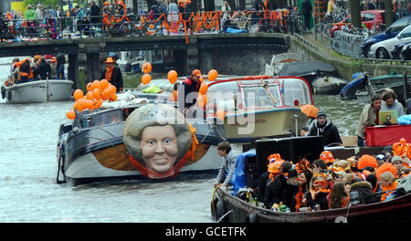 One of the Worlds biggest street parties takes place today as Holland celebrates Queensday. The canals and streets of Amsterdam are packed as tens of thousands celebrate the public holiday with models of Queen Beatrix of the Netherlands fixed to boats carrying party goers along the miles of canals. Stock Photo