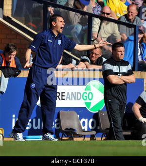 Brighton and Hove Albion manager Gus Poyet (left) and Southend United manager Steve Tilson on the touchline during the Coca-Cola League One match at Roots Hall, Southend. Stock Photo