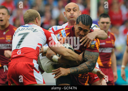 Rugby League - Engage Super League - Huddersfield Giants v Hull Kingston Rovers - Galpharm Stadium. Huddersfield Giants' David Fa'alogo is tackled by Hull Kingston Rovers' Michael Dobson and Michael Vella Stock Photo