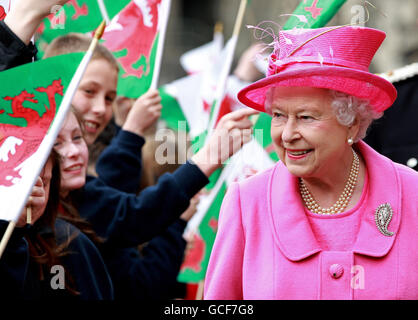 Queen Elizabeth II is cheered by school children with flags during a visit to Caernarfon Castle in north Wales, the castle where Prince Charles became the Prince of Wales. Stock Photo