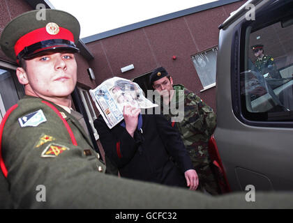 Able Seaman Eoin Gray covers his face with a newspaper as he leaves a court martial in McKee Barracks, Dublin, where he was sentenced to three months in military prison for disclosing sensitive information on the whereabouts of Navy ships. Stock Photo