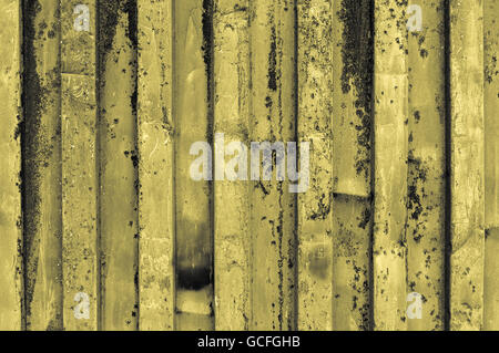 rough and rusty corrugated yellow grayish yellowish iron metal surface close-up Stock Photo
