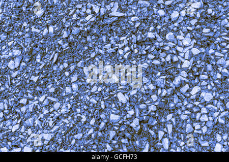 Rough brick ground shot mainly blue yellowish brownish indigo background Stock Photo