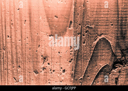 Rough grainy wood mainly orange grayish orangish colors hard light closeup Stock Photo
