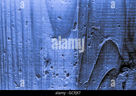 Rough grainy wood mainly blue light grayish bluish indigo colors hard light closeup Stock Photo