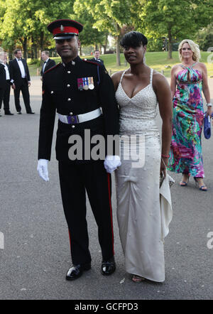 Lance Corporal Johnson Beharry VC and guest (name not known) arriving at The Caudwell Children Butterfly Ball at Battersea Evolution in south London. Stock Photo