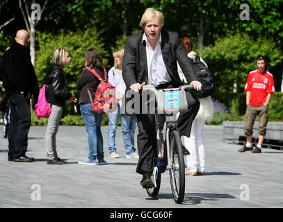 Mayor of London Boris Johnson rides a Barclays Cycle Hire bike as he arrives at a photocall at Potters Field Park, in central London, where Barclays was announced as the official sponsor of London's new cycle hire scheme, which launches in July. Stock Photo