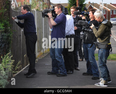 Conservative Party leader David Cameron is followed by the media as he does some door to door leafleting in Hucknall in Nottinghamshire after he had campaigned through the night in a final push for votes as General Election polling day approaches. Stock Photo