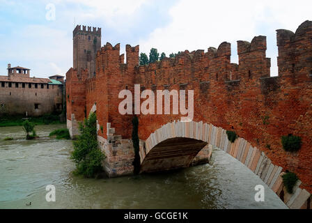 Verona, Italy. The Castelvecchio Bridge (Italian: Ponte di Castelvecchio) or Scaliger Bridge (Italian: Ponte Scaligero) is a fortified bridge over the Adige River. It was built (most likely in 1354-1356) by Cangrande II della Scala, to grant him a safe way of escape from the annexed eponymous castle in the event of a rebellion of the population against his tyrannic rule. The bridge was however totally destroyed by the retreating German troops on April 24, 1945. A faithful reconstruction begun in 1949 and was finished in 1951, with the exception of the left tower. Stock Photo