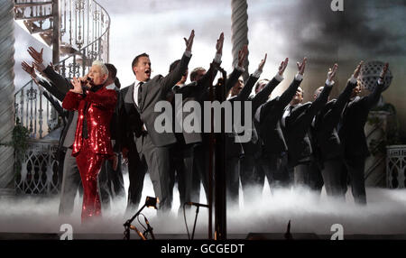 Rhydian (left, in red) and Only Men Aloud - winners of the NS&I Album of the Year - perform during the Classical Brit Awards at the Royal Albert Hall in west London. Stock Photo