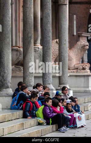 Group of  children on the steps of the Cremona Cathedral Stock Photo