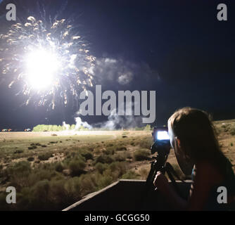 Girl photographing fireworks. Stock Photo