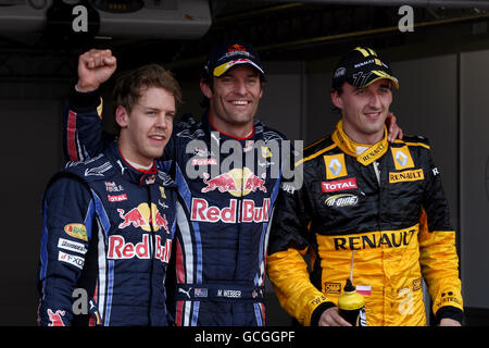 Qualifying top three in parc ferme (L to R): Sebastian Vettel (GER) Red Bull Racing, third; Mark Webber (AUS) Red Bull Racing, pole position; Robert Kubica (POL) Renault, second. Stock Photo