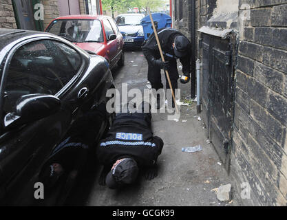Police officers search the streets in the red light district area of Bradford following the discovery of body parts in the River Aire, in Shipley, West Yorkshire. Stock Photo