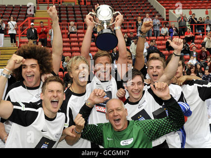 The X Factor team including (left to right) Jamie Archer, Lee Ryan and Jeff Brazier (top) celebrate winning the annual Soccer Six tournament at Charlton Athletic Football Club. Stock Photo