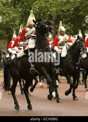A member of the Household Cavalry controls his rearing horse as troops march down the Mall, in central London, in the Colonel's Review of the Trooping the Colour parade, ahead of the Queen Elizabeth II's annual birthday parade next weekend. Stock Photo