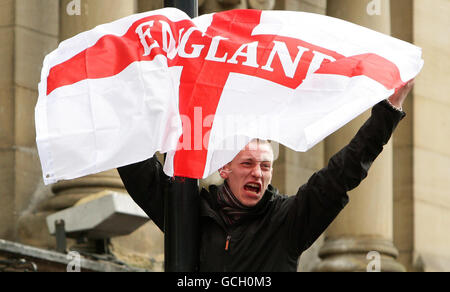 A man waves a flag as members of the English Defence League march through Newcastle city centre. Stock Photo