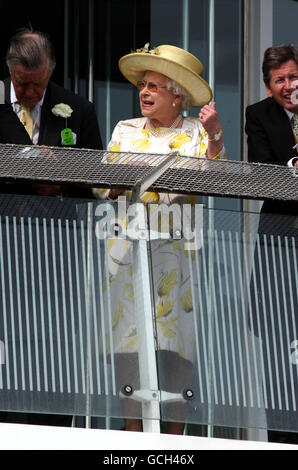 Her Majesty Queen Elizabeth II watches the Derby during the Investec Derby Festival at Epsom Downs Racecourse, Surrey. Stock Photo