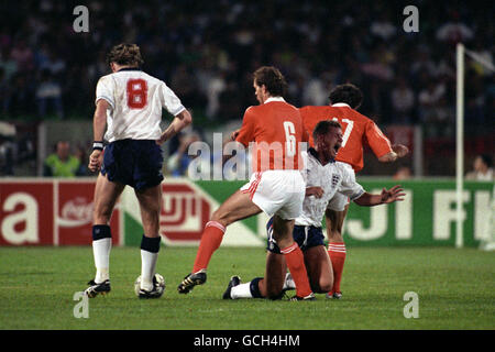 England's Paul Gascoigne is tackled by Netherlands' Hans GILLHAUS (r) and Jan WOUTERS (6) watched by England's Chris Waddle (8) Stock Photo