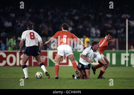 England's Paul Gascoigne is tackled by Netherlands' Hans GILLHAUS (r) and Jan WOUTERS (6) watched by England's Chris Waddle (8) Stock Photo