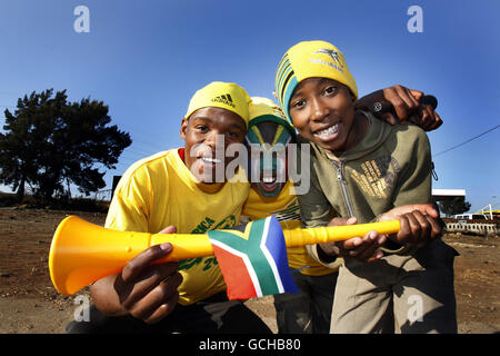 Young South African boys show off a Vuvuzela while on the streets of Soweta, Johannesburg, minutes before the opening match of the 2010 World Cup, with South Africa playing Mexico at the Soccer City stadium Stock Photo