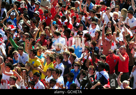 England fans celebrate England's goal against Slovenia during the World Cup Group Qualifying match at big screen show at Humberstone Gate, in Leicester city centre. Stock Photo