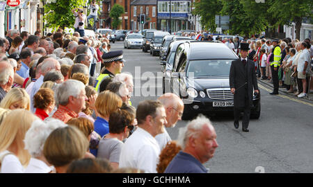 Mourners watch as the funeral cortege makes it's way through Wootton Bassett high street, during the repatriation of seven British servicemen, who were killed in Afghanistan. Stock Photo