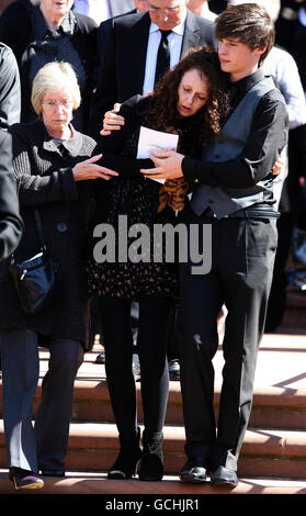 Tracey Nicholson (centre), the mother of school bus crash victim Kieran Goulding is consoled by son Adam (right) after Kieran's funeral at St James' Church, Whitehaven. Stock Photo