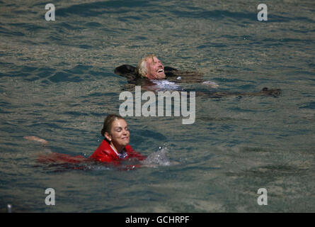 Sir Richard Branson riding a jet ski with stewardess Vicky Lewis and falling in after he conducted the world famous fountains at the Bellagio hotel in Las Vegas, USA. Stock Photo