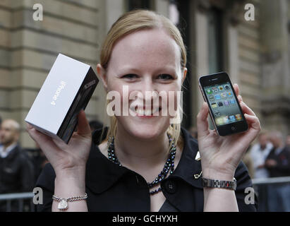 Jan Taylor holds her new iPhone outside the Apple store on Buchanan Street in Glasgow as the iPhone 4 goes on sale across the UK. Stock Photo