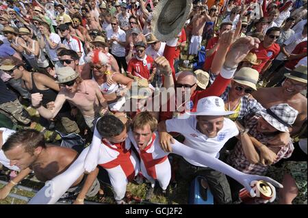 A huge crowd gathers to watch the England World Cup match against Germany on a big screen during Glastonbury Festival 2010 at Worthy farm in Pilton, Somerset. Stock Photo