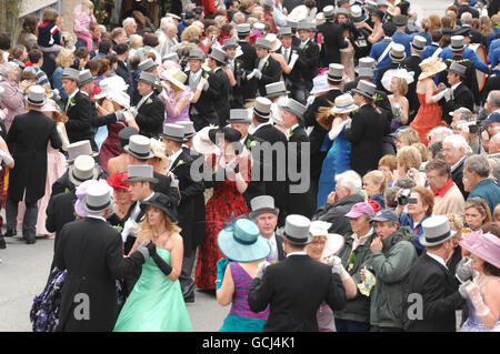 A general view of The Midday Dance taking place at Helston Flora Day in Cornwall. The Midday dance is the feature dance during a day of dancing and celebrations through the streets of Helston. The ancient event is held annually during early May and is pre-Christian with its origins in pagan rites of Spring and fertility Stock Photo