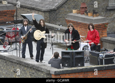 (Left to right) Fran King as Paul McCartney, Scott Maher as John Lennon, Rob McKinny as George Harrison and Binder as Ringo Starr the cast of 'Get Back - The Story of The Beatles' perform on the roof of Dublin's Olympia Theatre to promote their show which runs from Wednesday 4th August until Sunday 8th August. Stock Photo