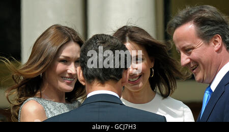 French First Lady, Carla Bruni-Sarkozy (left), and her husband, French President Nicolas Sarkozy (2nd left), share a light moment with British Prime Minister David Cameron (right) and his wife Samantha during a parade at The Royal Hospital Chelsea, in London. Stock Photo